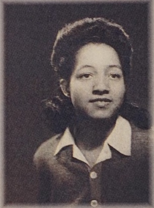 Black and white photo of Irene as a young woman wearing a shirt with a collar and a half updo.