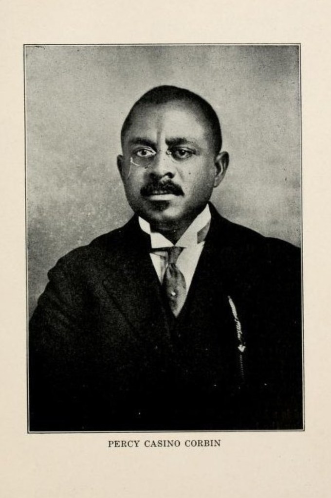 Black and white portrait of a man wearing a suit tie and glasses glancing into the distance with the name "Percy Casino Corbin" written below