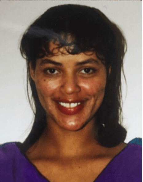 Photo of smiling woman with black hair and bangs 