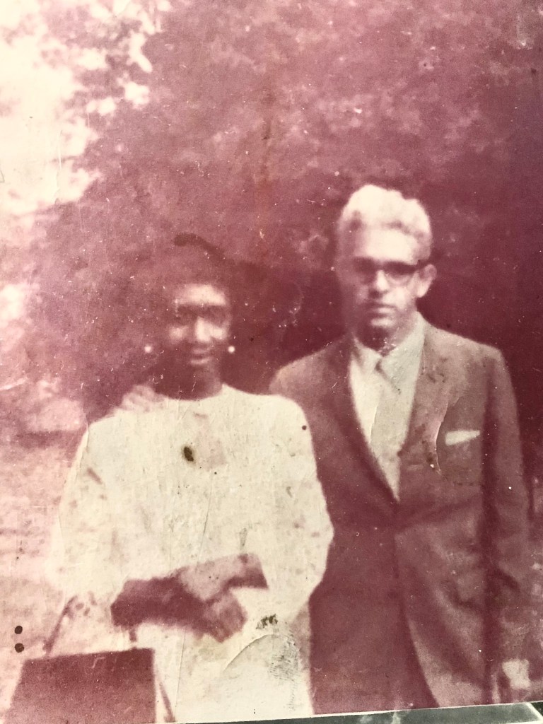 a vintage photograph of a black man and a woman posing together for a photo