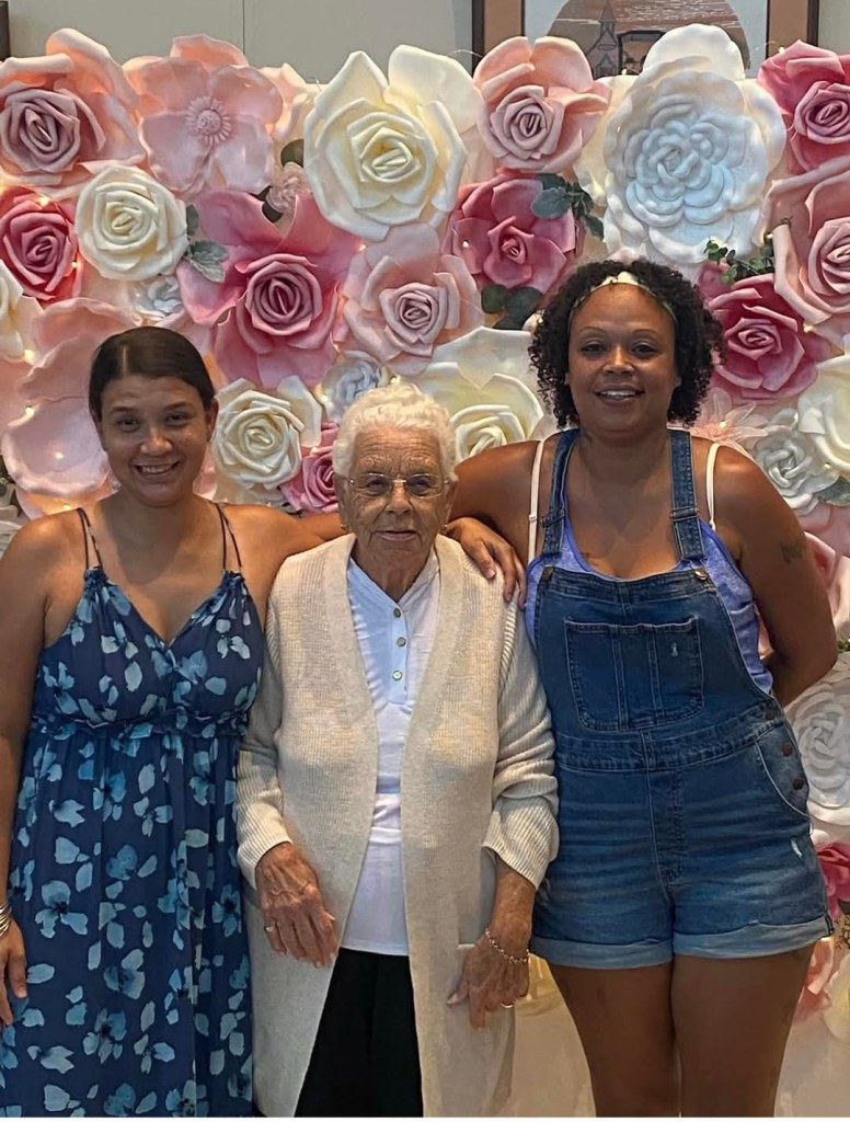 three different generations of women posing for a photo together