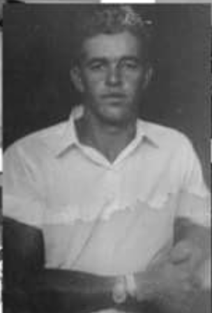 black and white photo of a young man sitting down