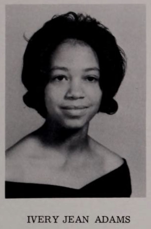 Black and white yearbook image of a young woman posing for her senior portrait.