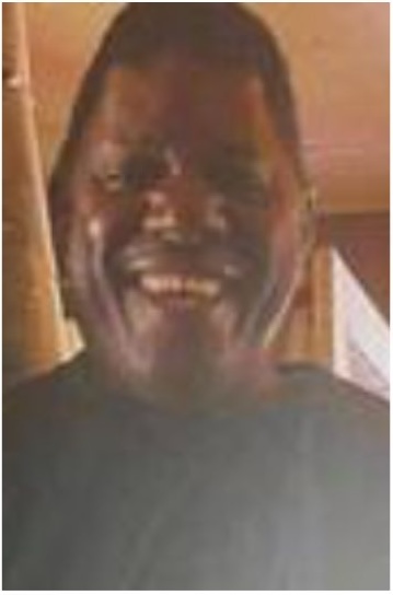 Image of smiling African American man in black shirt
