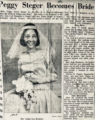 1962 newspaper clipping about a young woman's wedding. The article makes several references to the bride's wedding dress and other attendees attire. The photo is of the bride sitting and smiling. She has a veil that comes to her shoulders, pearls around her neck, and a bouquet in her lap.
