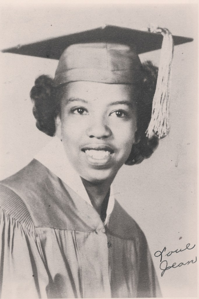 A graduation photo of a young Black woman in her cap and gown